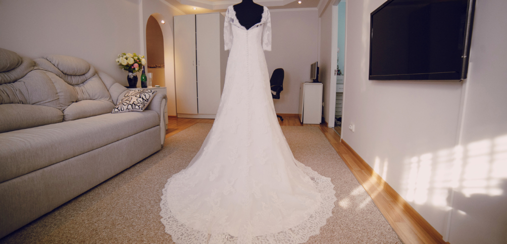 A beautiful wedding dress waits in the bride's dressing room for the bride to arrive