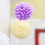 Hanging tissue poms decorate a wedding reception