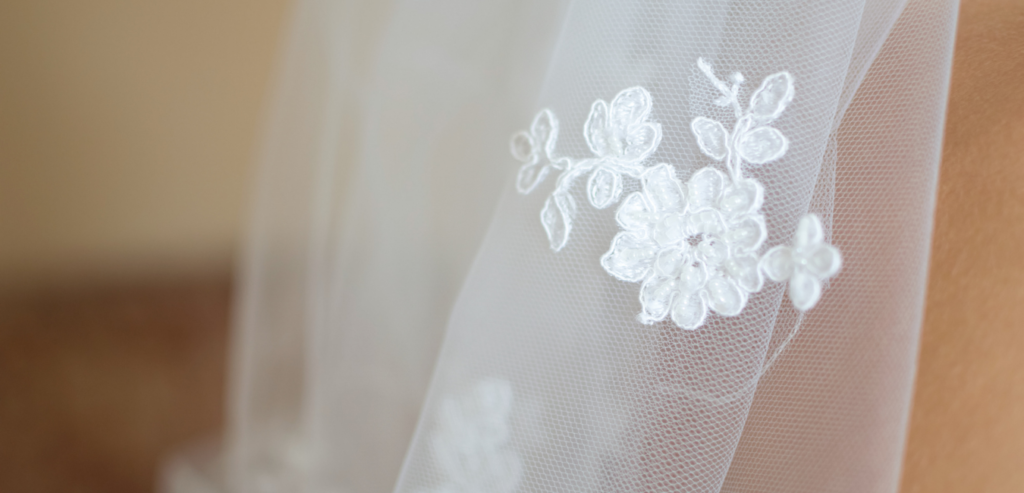 A lace applique added to a tulle bridal veil