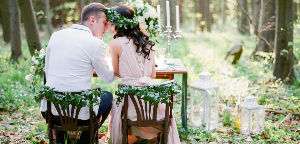 Bridal couple seated at rustic wedding