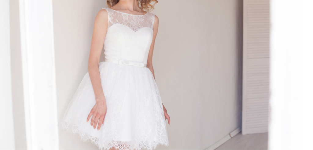 A short wedding dress with a delicate, sleeveless, lace top