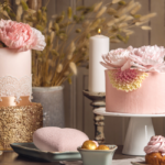 Small, wedding cakes and cupcakes displayed on a table